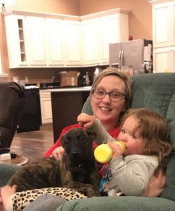 mother and son with Dutch Shepherd puppy